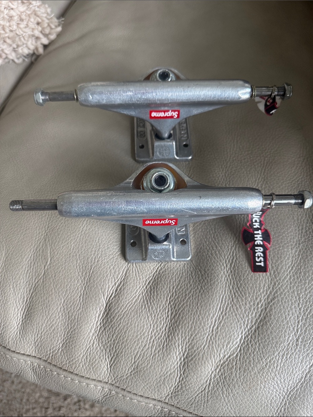Supreme Silver Skateboard Trucks with Red Logos